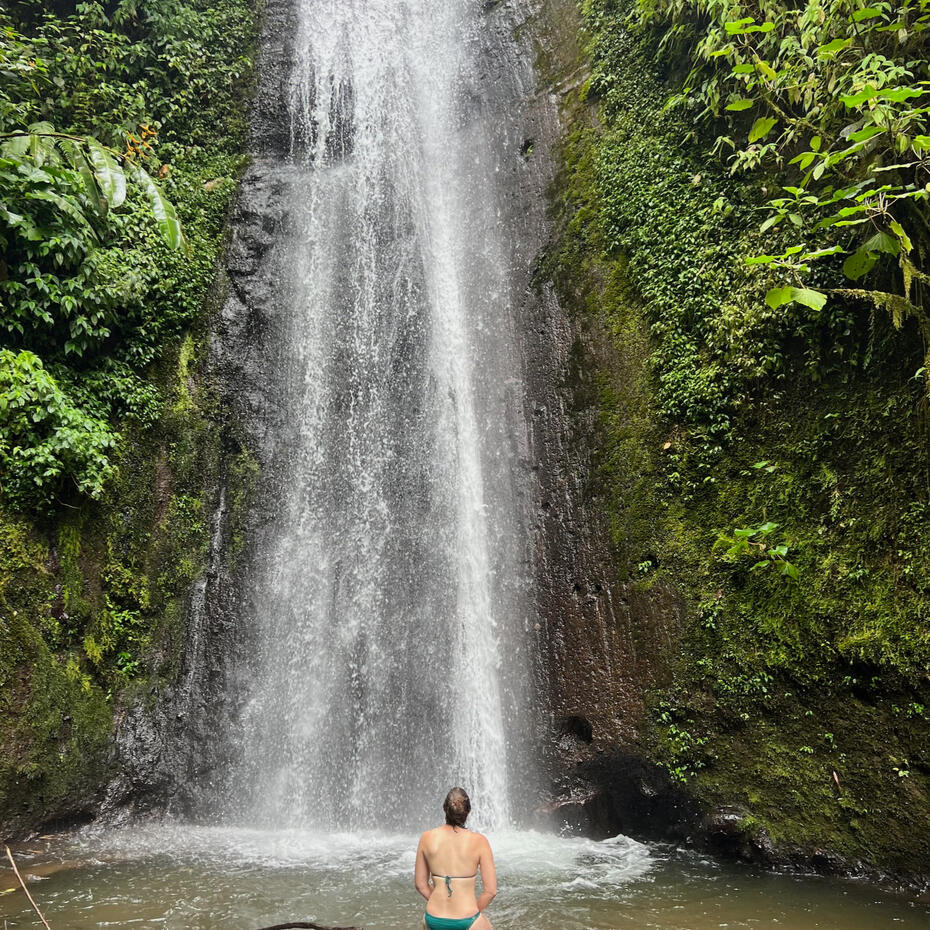 Women sitting in front of a waterfall.